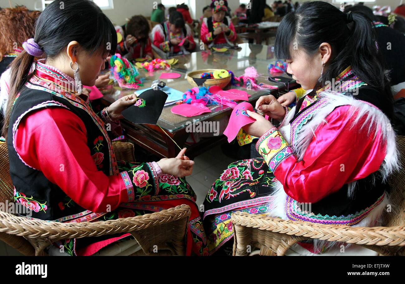 (150614) -- CHENGDU, June 14, 2015 (Xinhua) -- File photo taken on March 1, 2012 shows women of Qiang ethnic group embroidering in Yinxing Village of Wenchuan County, southwest China's Sichuan Province. Traditional crafts like embroidering have been well-developed after the 2008 Wenchuan earthquake. As one of the countries which suffers most from natural disasters, China has improved greatly its ability to deal with natural disasters and post-disaster reconstruction. Having witnessed a deadly earthquake of magnitude 8.0 in Wenchuan in 2008 and a 7.0 magnitude quake in Lushan in 2013, Si Stock Photo