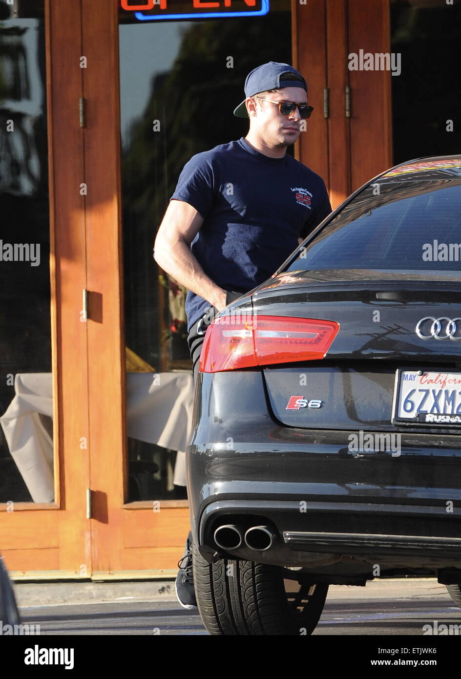 Actor Zac Efron craddles his dog back to his car after having lunch at  Locali in Los Angeles. Featuring: Zac Efron Where: Los Angeles, California,  United States When: 04 Mar 2015 Credit: