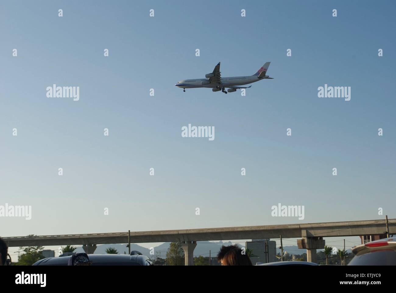 plane descending at vancouver airport landing take off sky airplane air airport night market Stock Photo