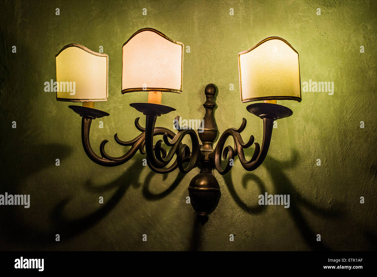 Old lamps on the wall with shadows stretching beneath Stock Photo Alamy