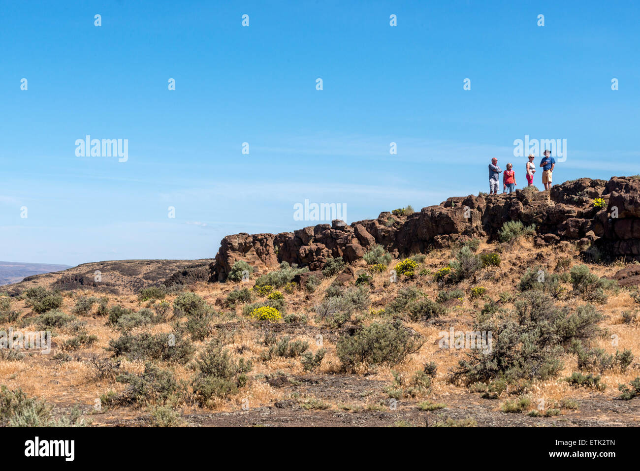 Tourists look at the view over the Columbia River towards the Ginkgo Petrified Forest State Park in Washington USA. Stock Photo