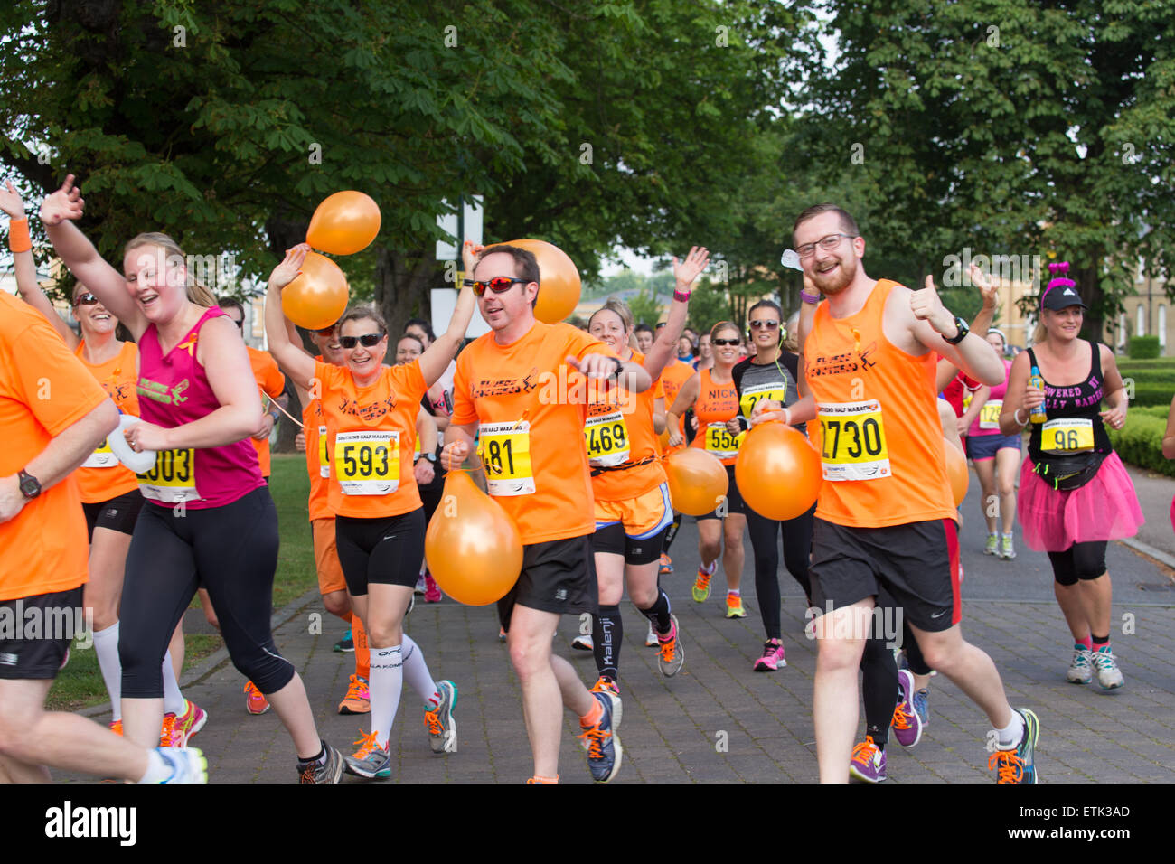 Southend-On-Sea, UK. 14th June 2015. Runners from 'Southend Flyers Running Club' dressed in orange in Memory of Nick Palmer, 37 from Great Wakering who collapsed and died after crossing the finishing line last year.  This years race passed without major incident. Credit:  Graham Eva/Alamy Live News Stock Photo