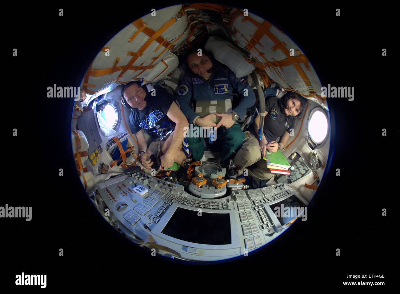 View of the Expedition 43 crew members commander Terry Virts of NASA and Cosmonaut Anton Shkaplerov of Roscosmos and Italian astronaut Samantha Cristoforetti from European Space Agency secured inside the Russian Soyuz TMA-15M spacecraft as it prepares to return to Earth June 8, 2015 from the International Space Station. The crew is returning after more than six months onboard the ISS. Stock Photo