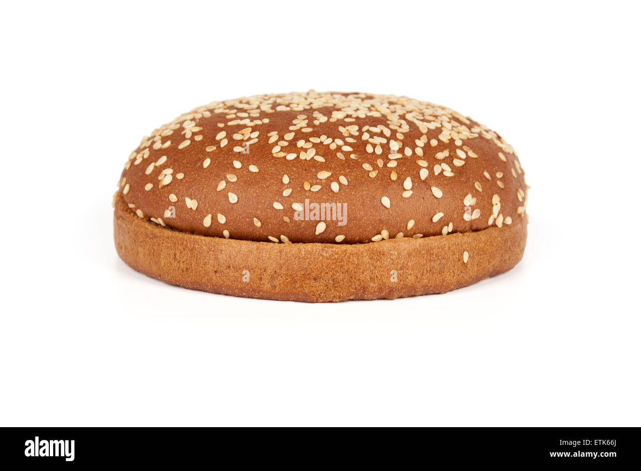 One dark hamburger bun with sesame seeds sliced in two halves isolated on white background Stock Photo