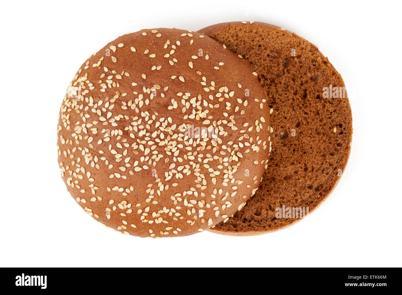 Upper view on dark sliced bun with sesame seeds for hamburger. Isolated on white. Stock Photo