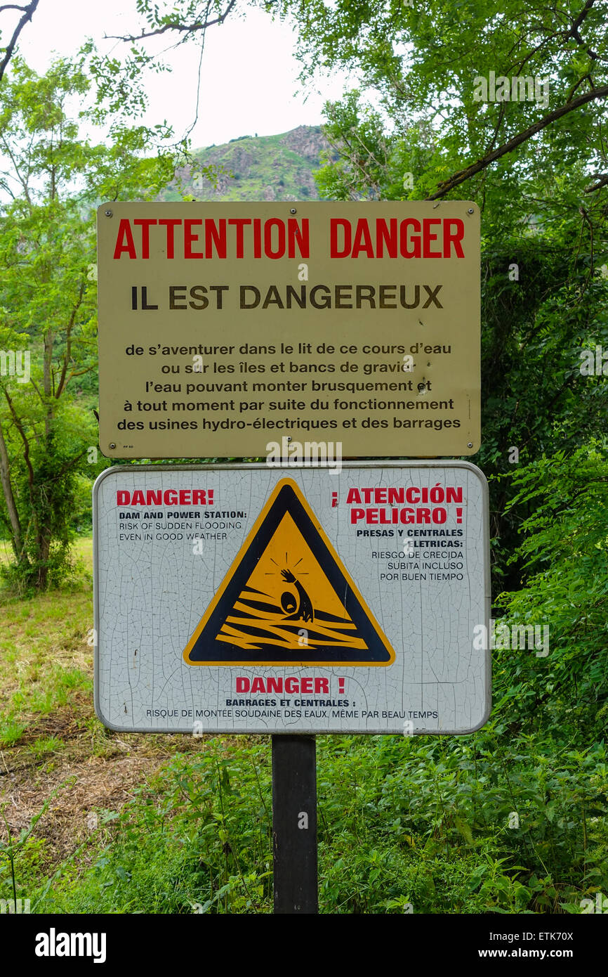 Warning sign in French about danger of flooding river Stock Photo