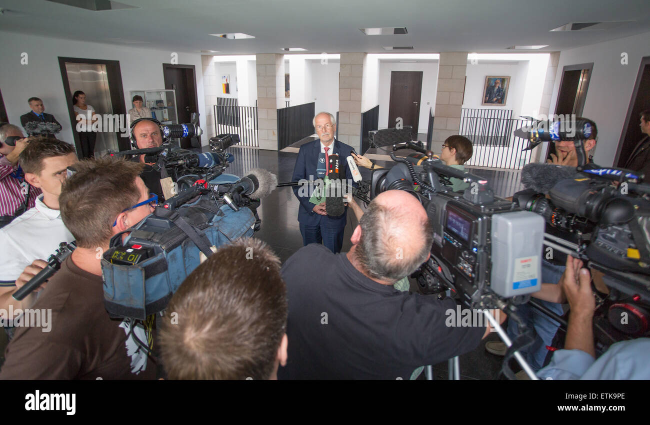 Karlsruhe, Germany. 12th June, 2015. German Federal Prosecutor General Harald Range (C) has dropped the probe into allegations that one of German Chancellor Angela Merkel's mobile phones had been spied on and responds to questions by journalists at the federal prosecutor's office in Karlsruhe, Germany, 12 June 2015. Photo: Ralf Stockhoff/dpa/Alamy Live News Stock Photo