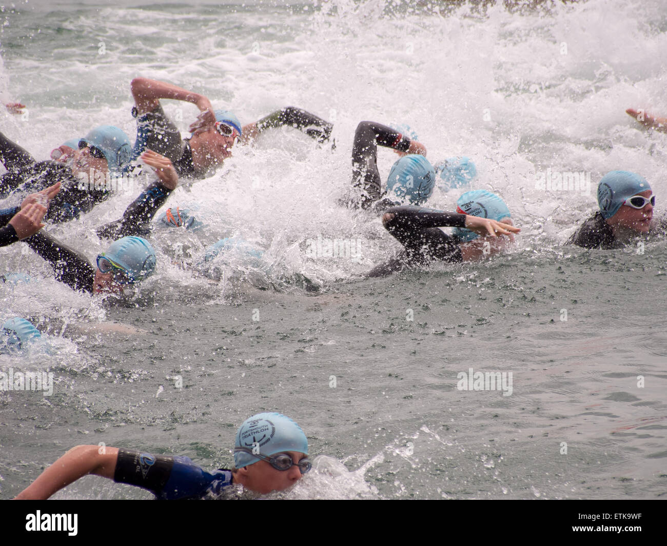 Portsmouth, UK. 14th June, 2015. Participants in the under 16 triathlon start their event with a swim in the Solent during the Portsmouth Try a tri triathlon. The event consisted of a number of sprint triathlons of different lengths to accomodate differing abilities. Credit:  simon evans/Alamy Live News Stock Photo