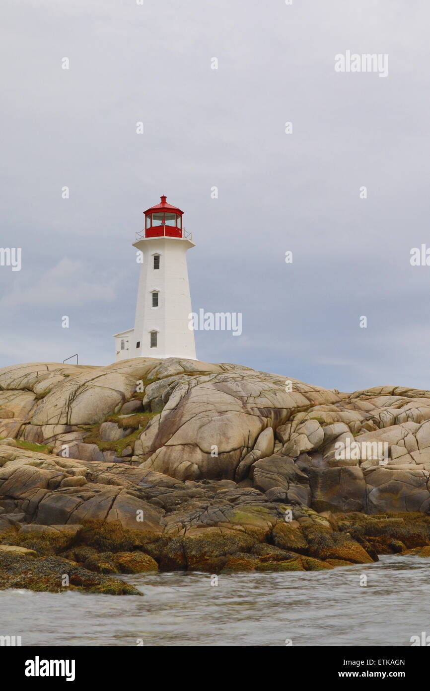 Peggys Cove lighthouse, light house, Peggy's Cove Nova Scotia, Canada with sunset sky colors landscape. Stock Photo