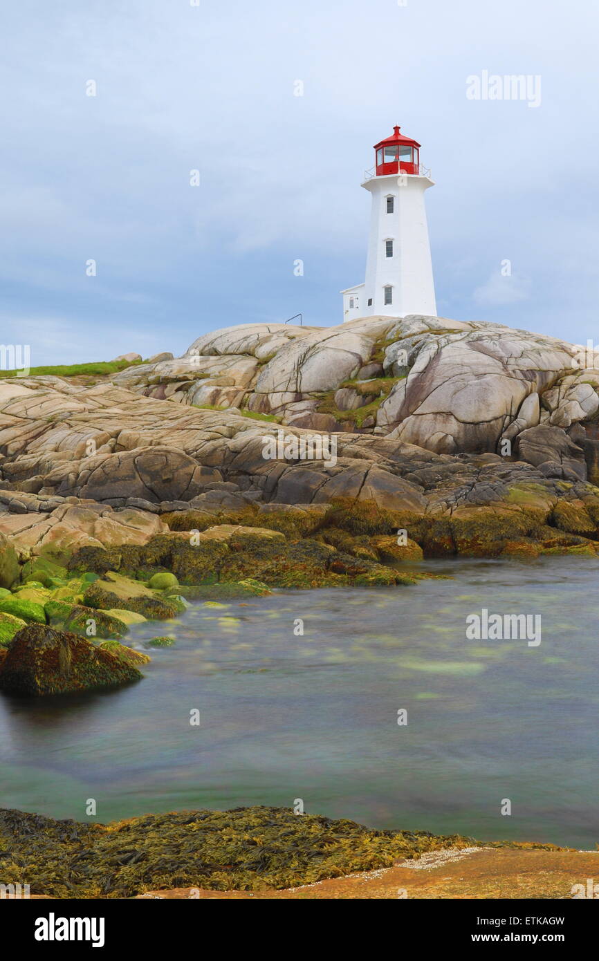 Peggys Cove lighthouse, light house, Peggy's Cove Nova Scotia, Canada with sunset sky colors landscape. Stock Photo