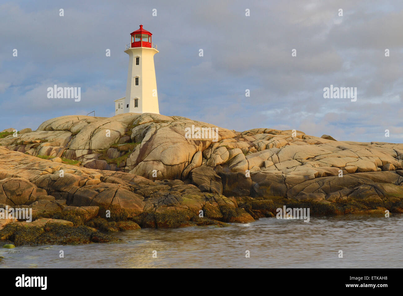 Peggys Cove lighthouse, light house, Peggy's Cove Nova Scotia, Canada with sunset sky colors landscape. Stock Photo