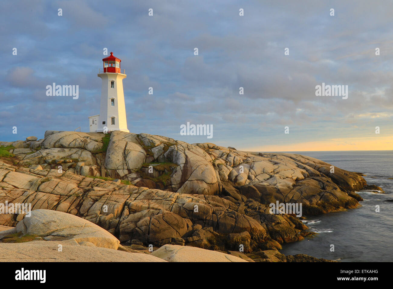 Peggys Cove lighthouse, light house, Peggy's Cove Nova Scotia, Canada with sunset sky colors landscape. Stock Photo