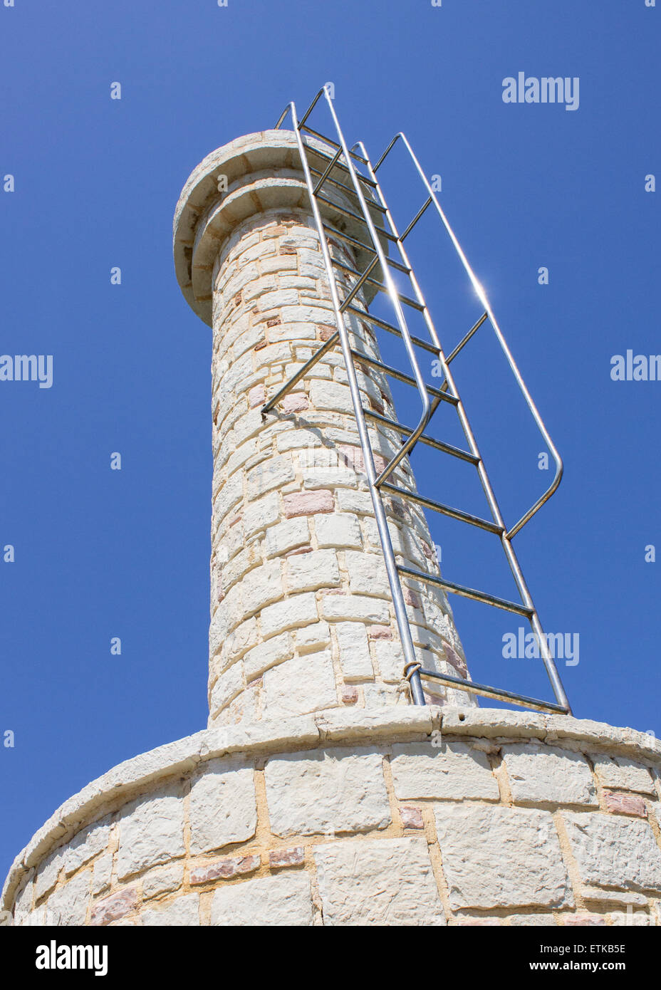 The old lighthouse overlooking the Port of Hersonissos in Crete, Greece. Stock Photo