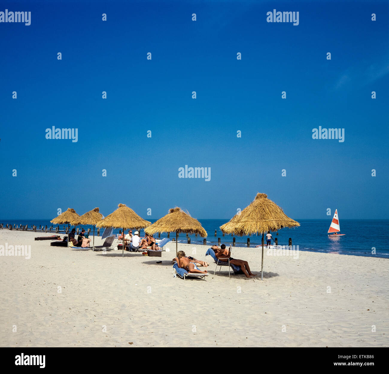 Holidaymakers sunbathing on beach, Gambia, West Africa Stock Photo