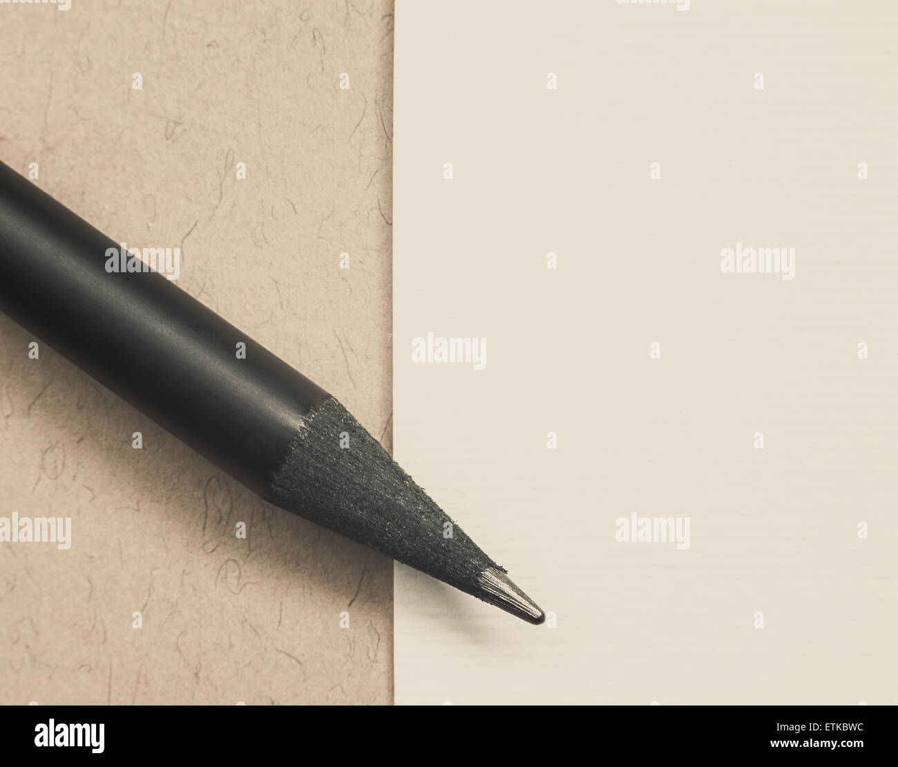 Black new wooden pencil and white paper, simple composition with empty space. Stock Photo