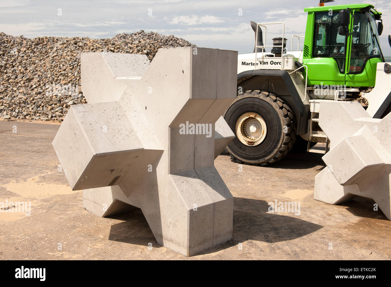Xblocs and basalt blocks are ready to be used in the new breakwater of the new marina at the Dutch seaside resort Cadzand Stock Photo