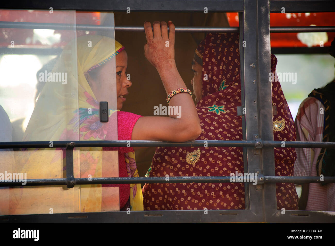 Indian women wearing colourful  saris on a passenger bus, Jaipur, Rajasthan, India Stock Photo