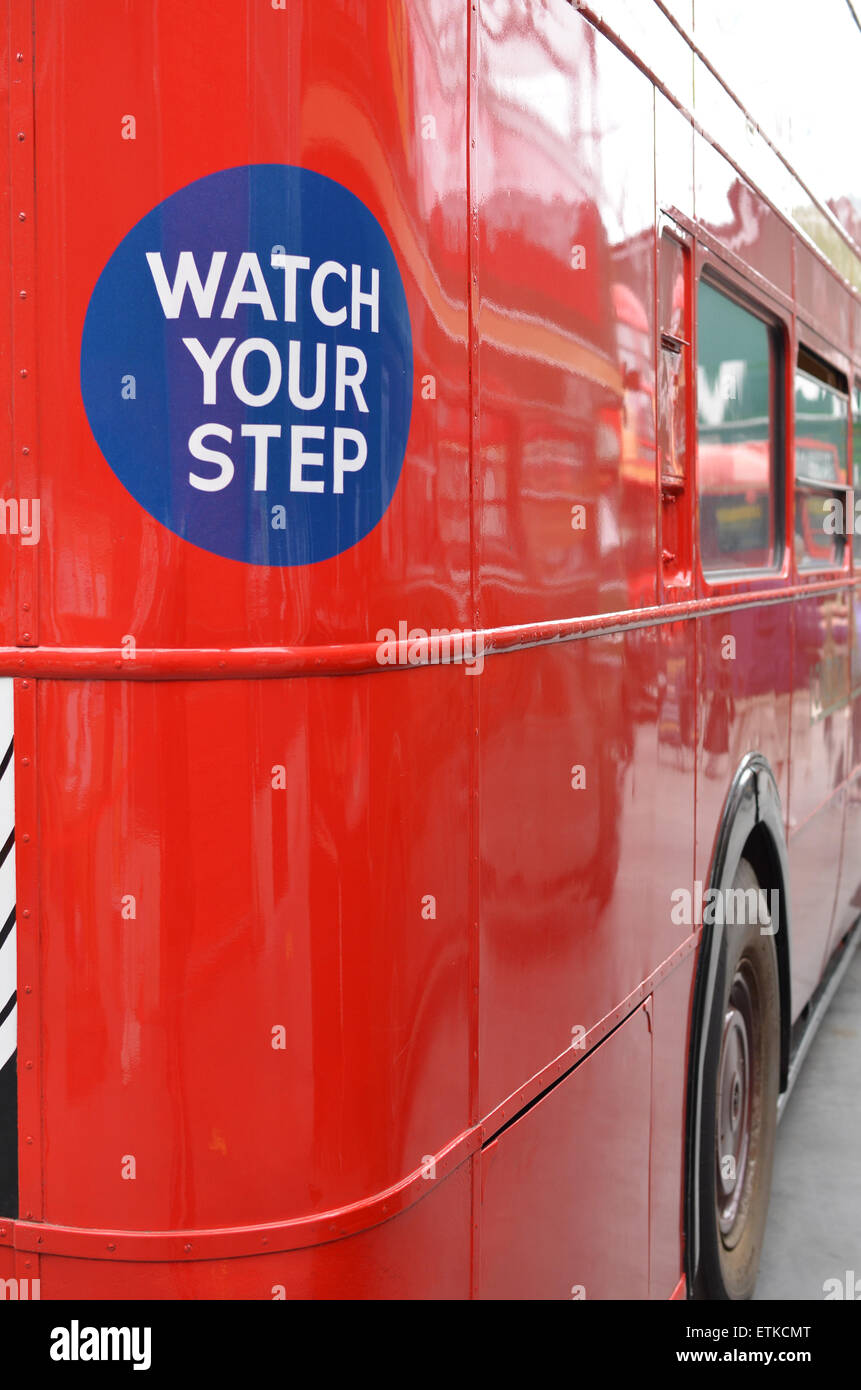 Watch your step sign on the rear of a London bus. Stock Photo