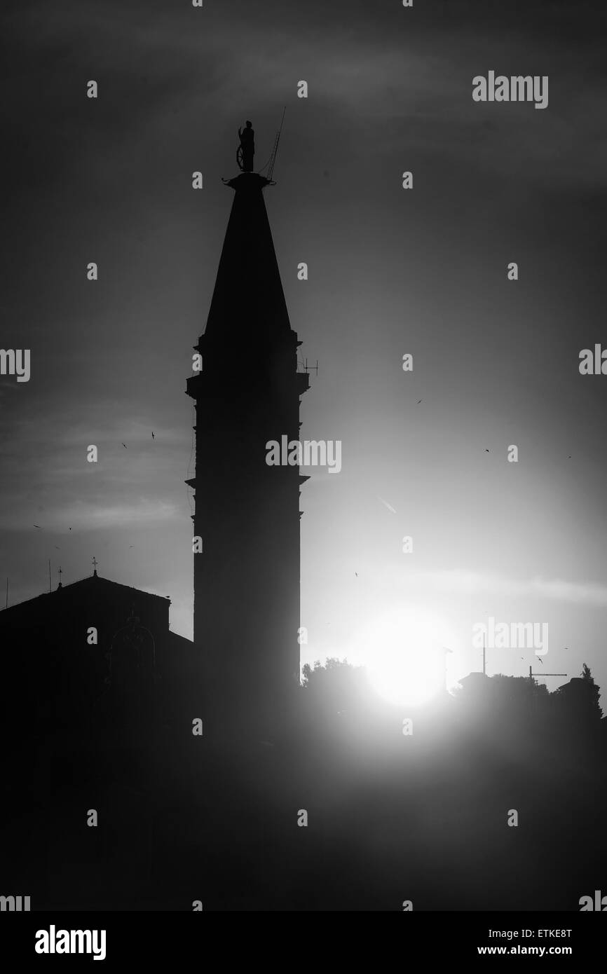 A view of the silhouette of Saint Euphemia bell tower at sunset  in Rovinj, Croatia. Stock Photo