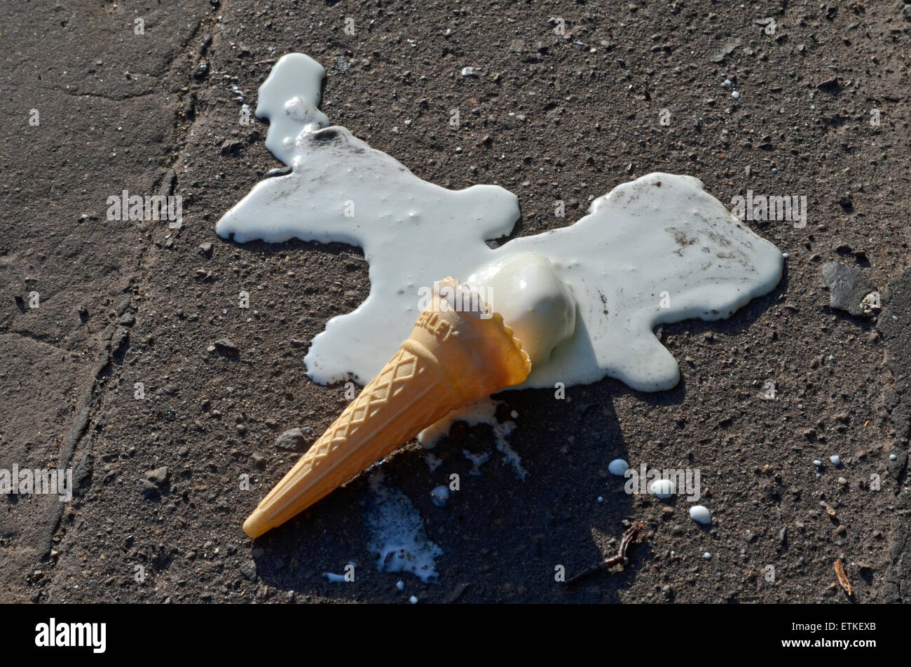 Melting ice cream  cone on the pavement Stock Photo