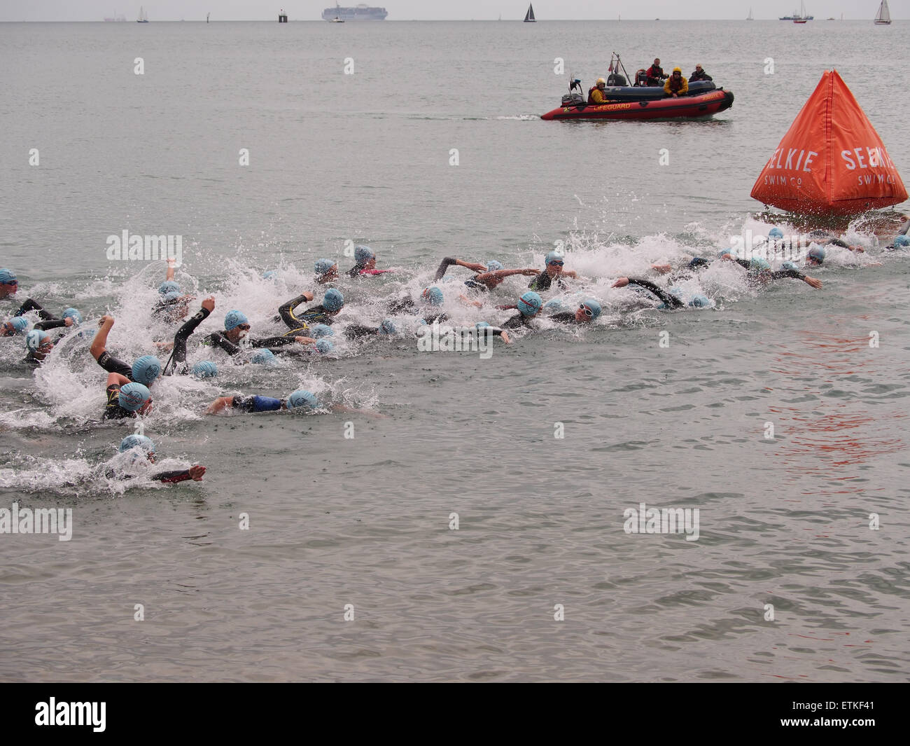 Swimmers swim around a buoy in the Solent during a triathlon event in Southsea, Portsmouth, England Stock Photo