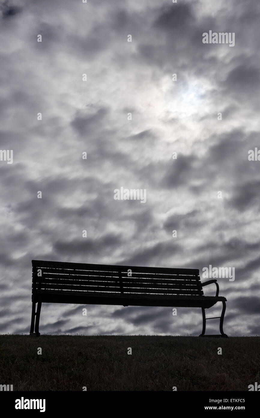 Bench With Dark, Moody Clouds Stock Photo