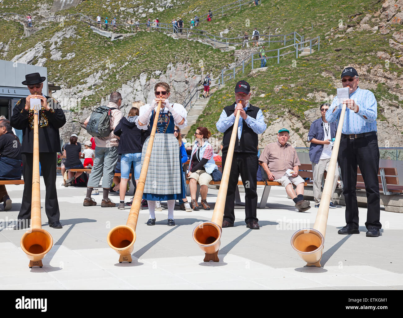 MOUNT PILATUS - JULY 13: Unidentified people playing traditional swiss music with alphorns on July 13, 2013 on the top of Pilatu Stock Photo