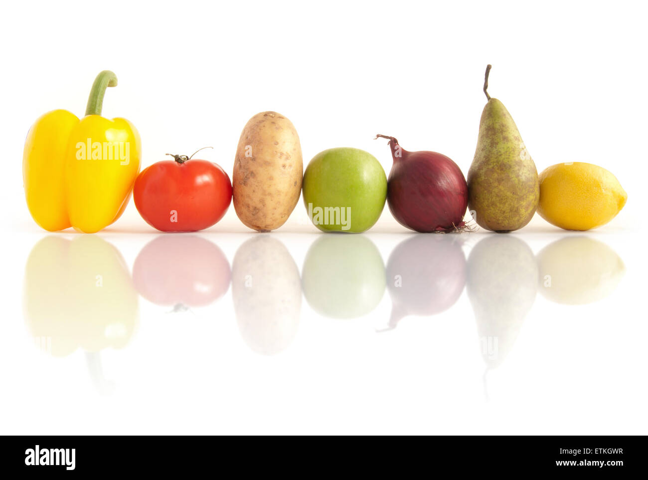 Organic fruits and vegetables in a row over a white background Stock Photo