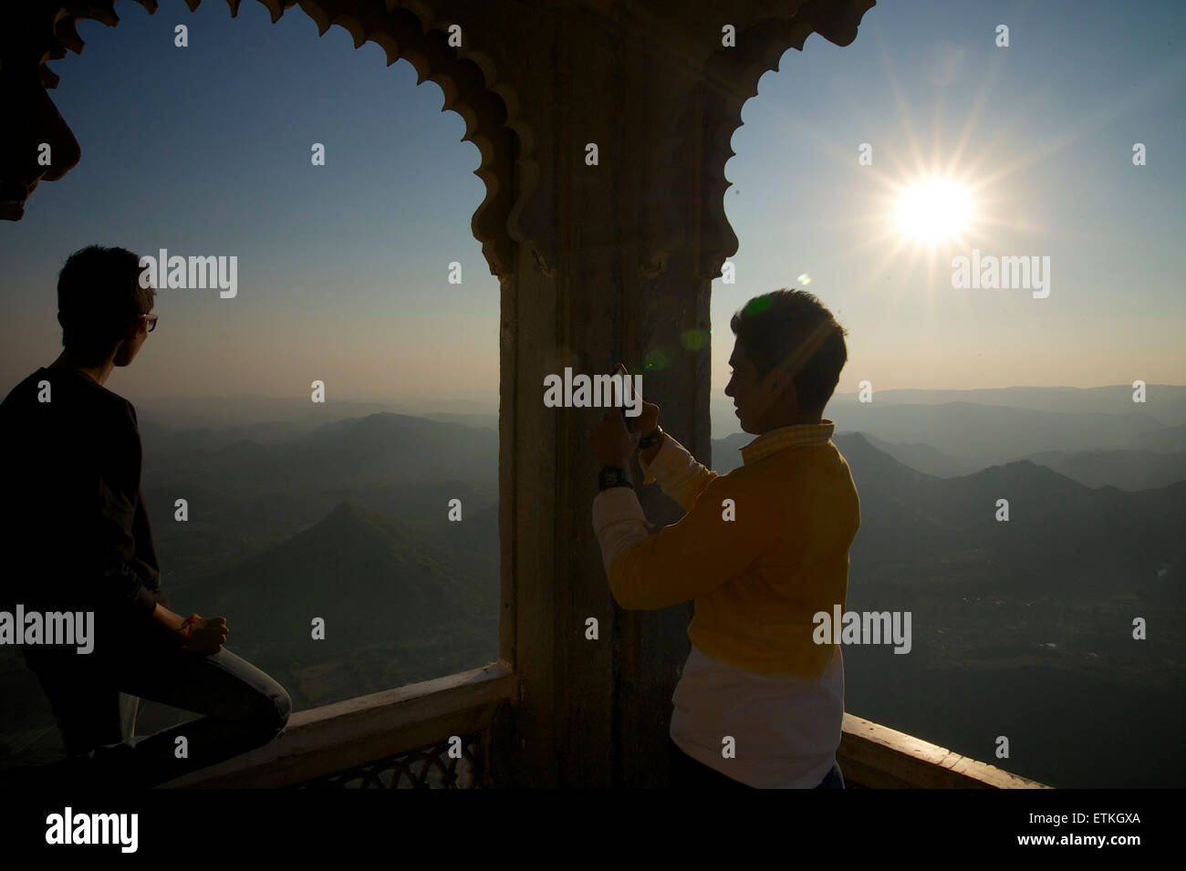 Indian friends taking mobile phone photographs at the Monsoon Palace, Udaipur, Rajasthan, India Stock Photo