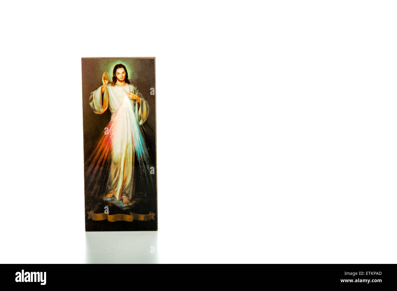 Isolated on white background, an image of the Merciful Jesus with blank ribbon at the bottom without writings Stock Photo