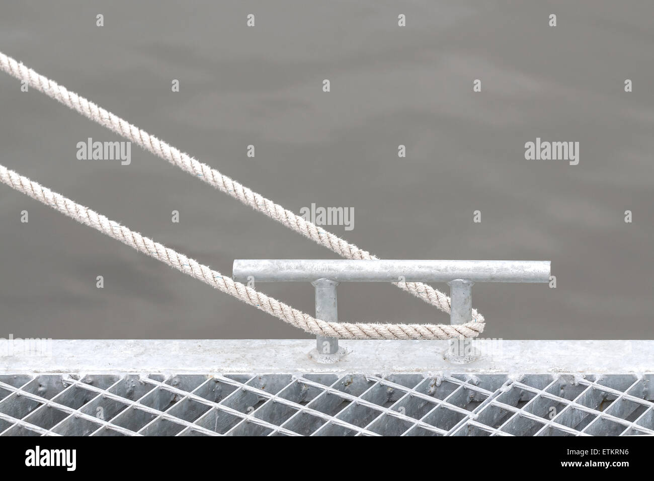 Marina bollard with rope, marine background with space for text. Stock Photo
