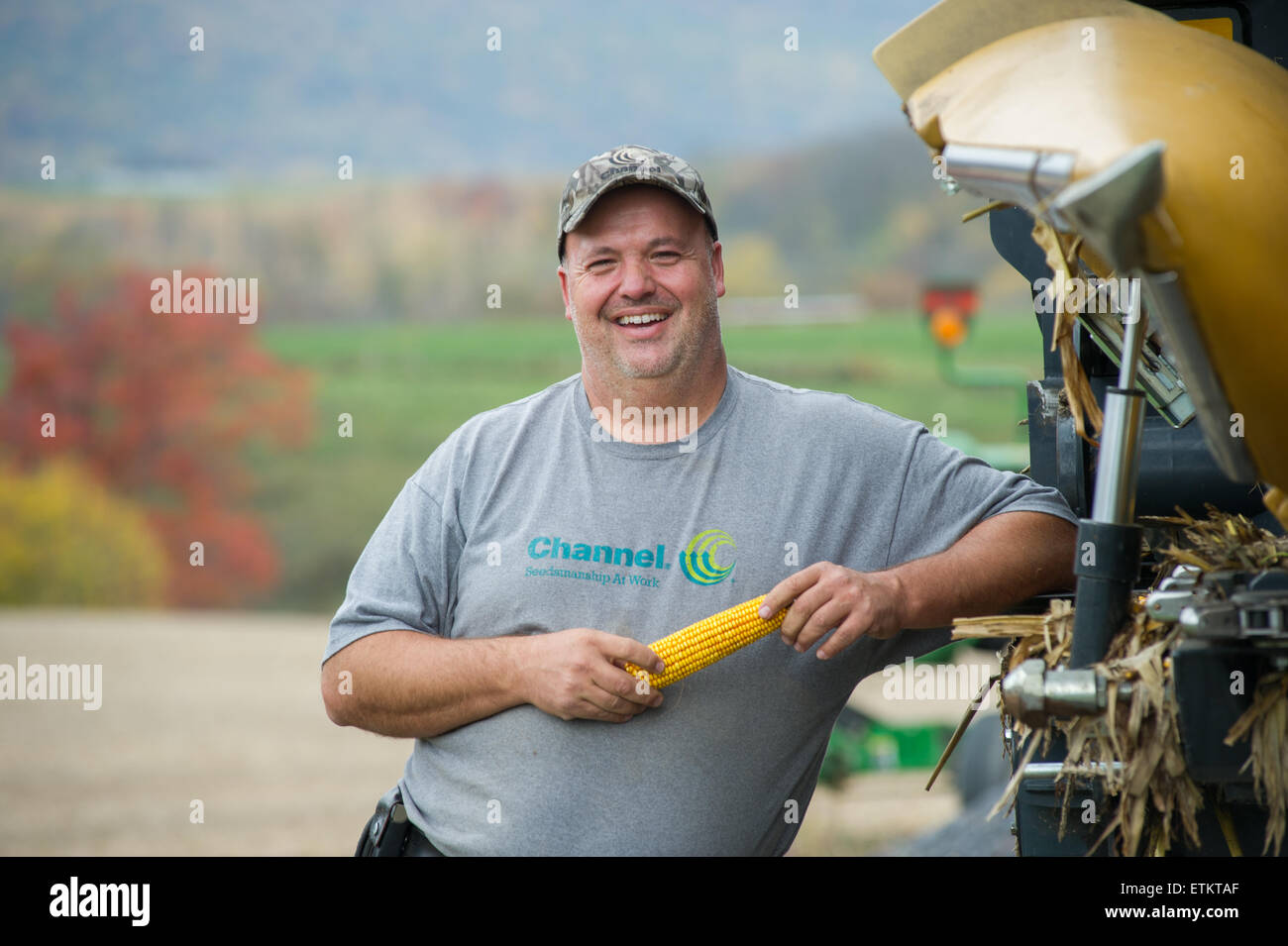 Farmer holding cob of corn in Dalmatia, Pennsylvania, USA Stock Photo