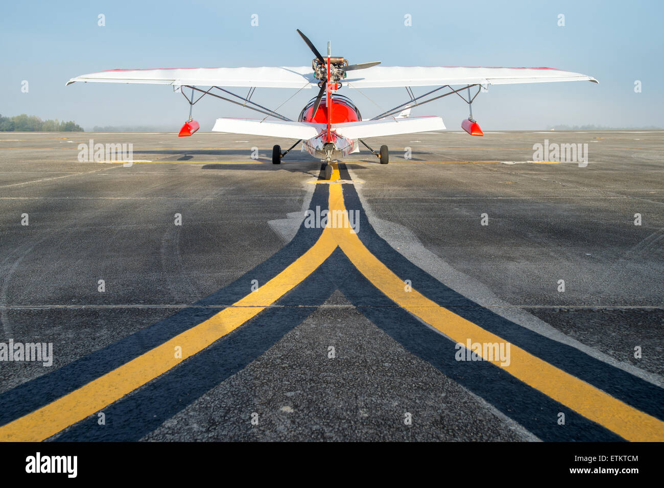 The rear side of a Searey seaplane sitting on the runway showing the painted runway lines  USA Stock Photo