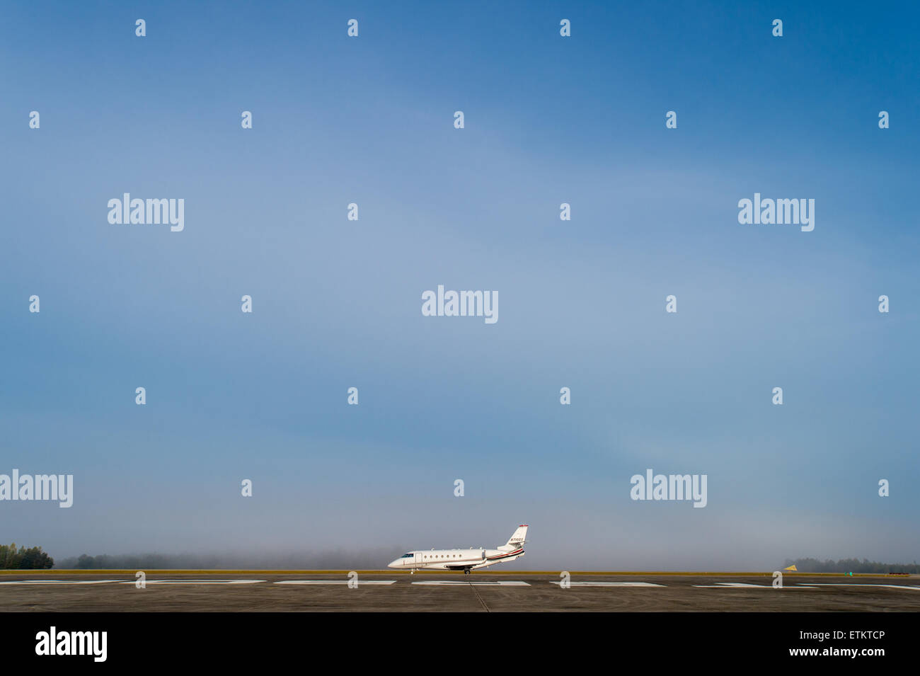 The side view of a plane sitting on the runway  USA Stock Photo