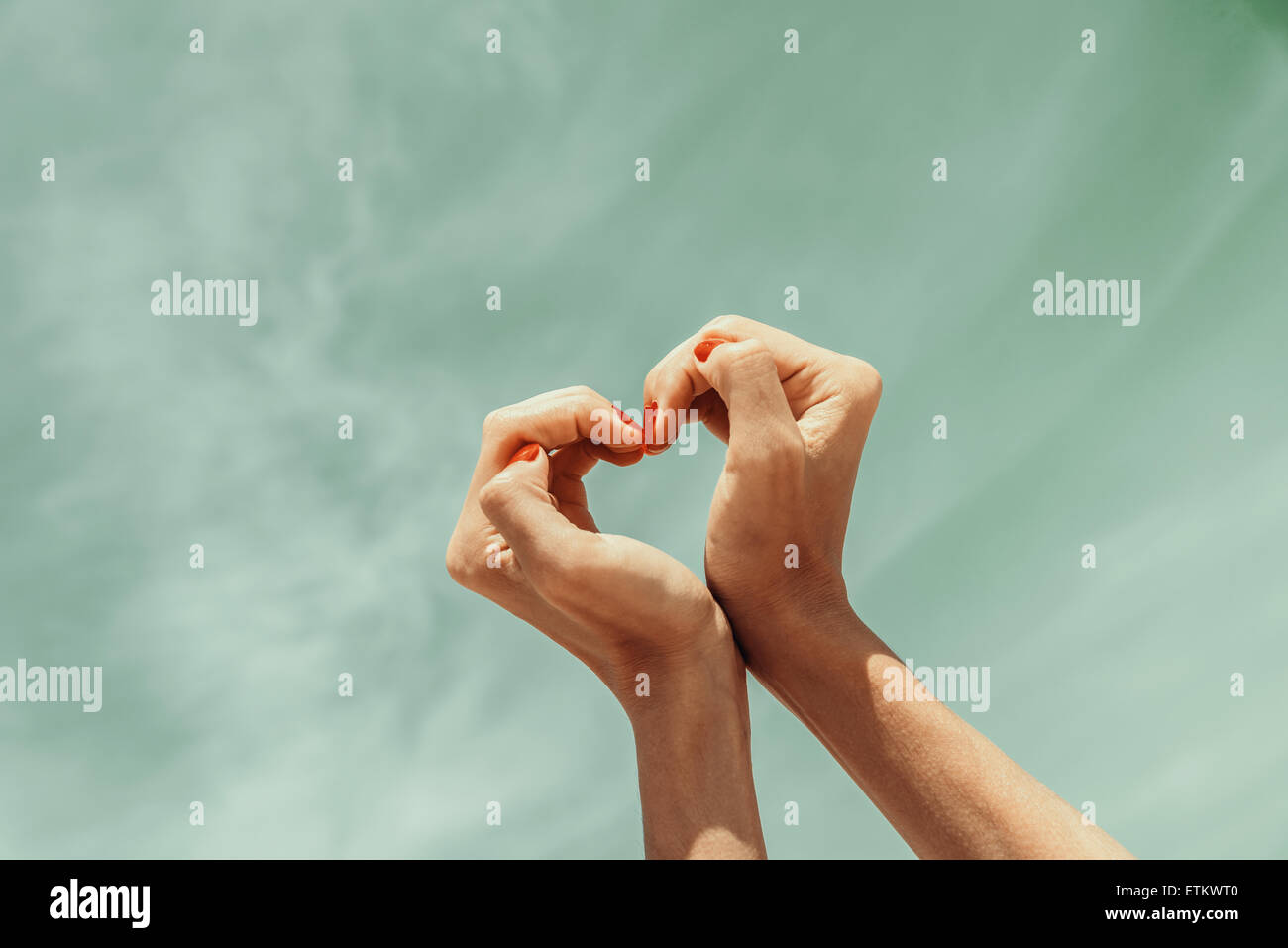 Portrait of asian couple making heart shape with hands posing isolated over  white background Stock Photo - Alamy