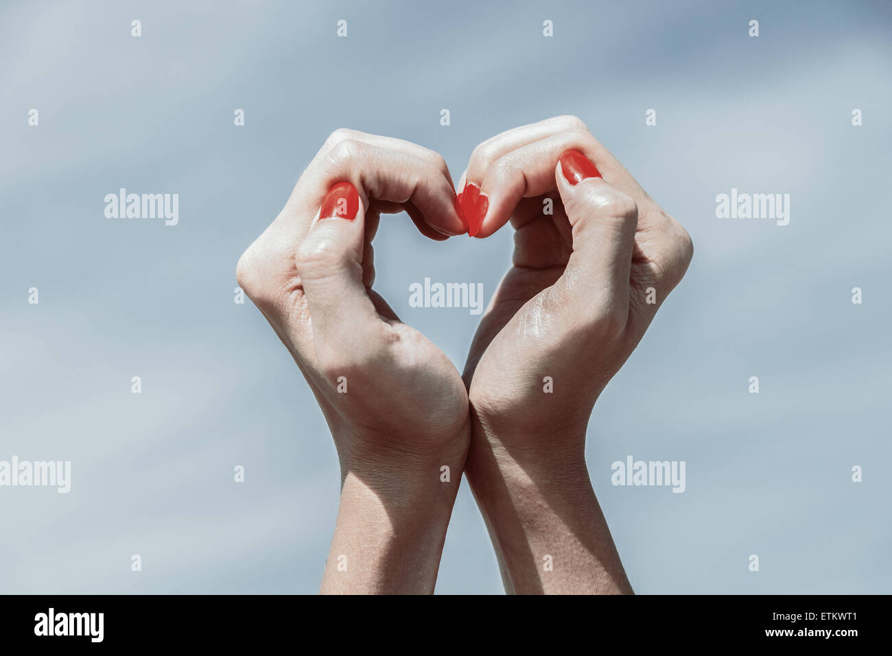 Retro Photo Of Girl Hands In Heart Shape On Blue Sky Stock Photo - Alamy