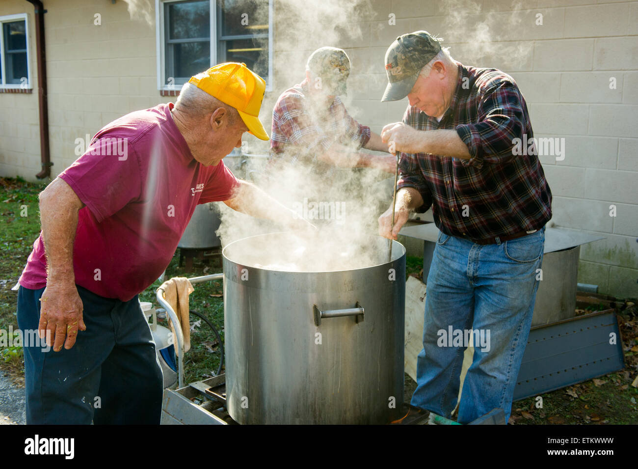 Men boiling stuffed hams outside, in large pans in St Mary's County