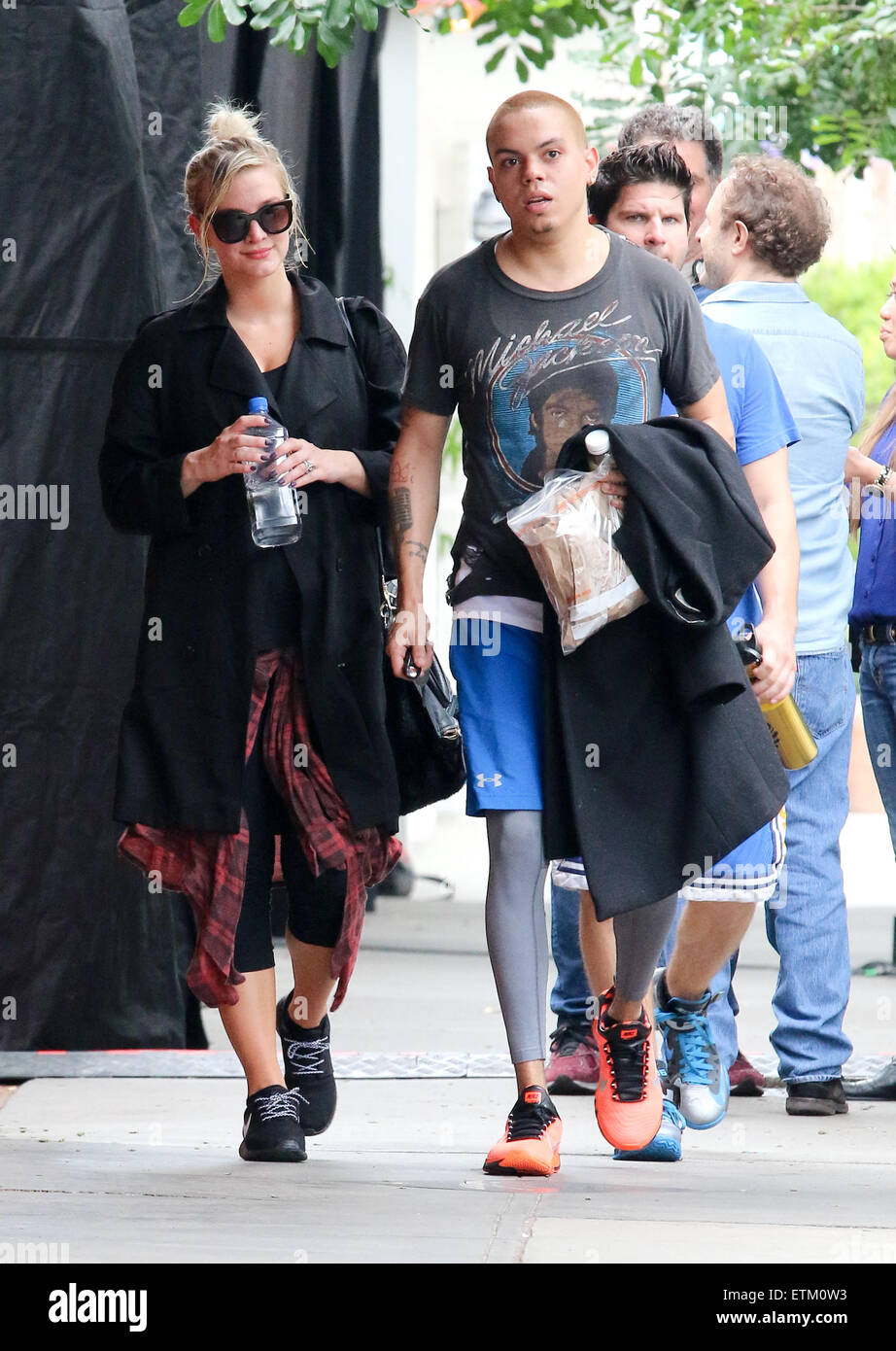 A pregnant Ashlee Simpson and husband Evan Ross holding hands leaving
