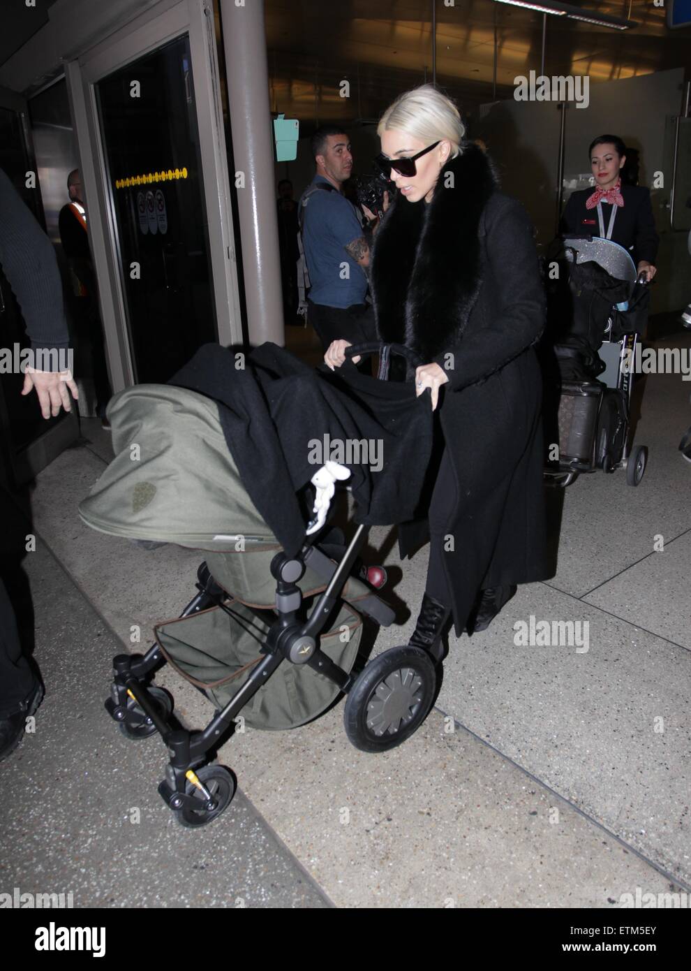 Blonde Kim Kardashian pushes baby North West in a stroller as she