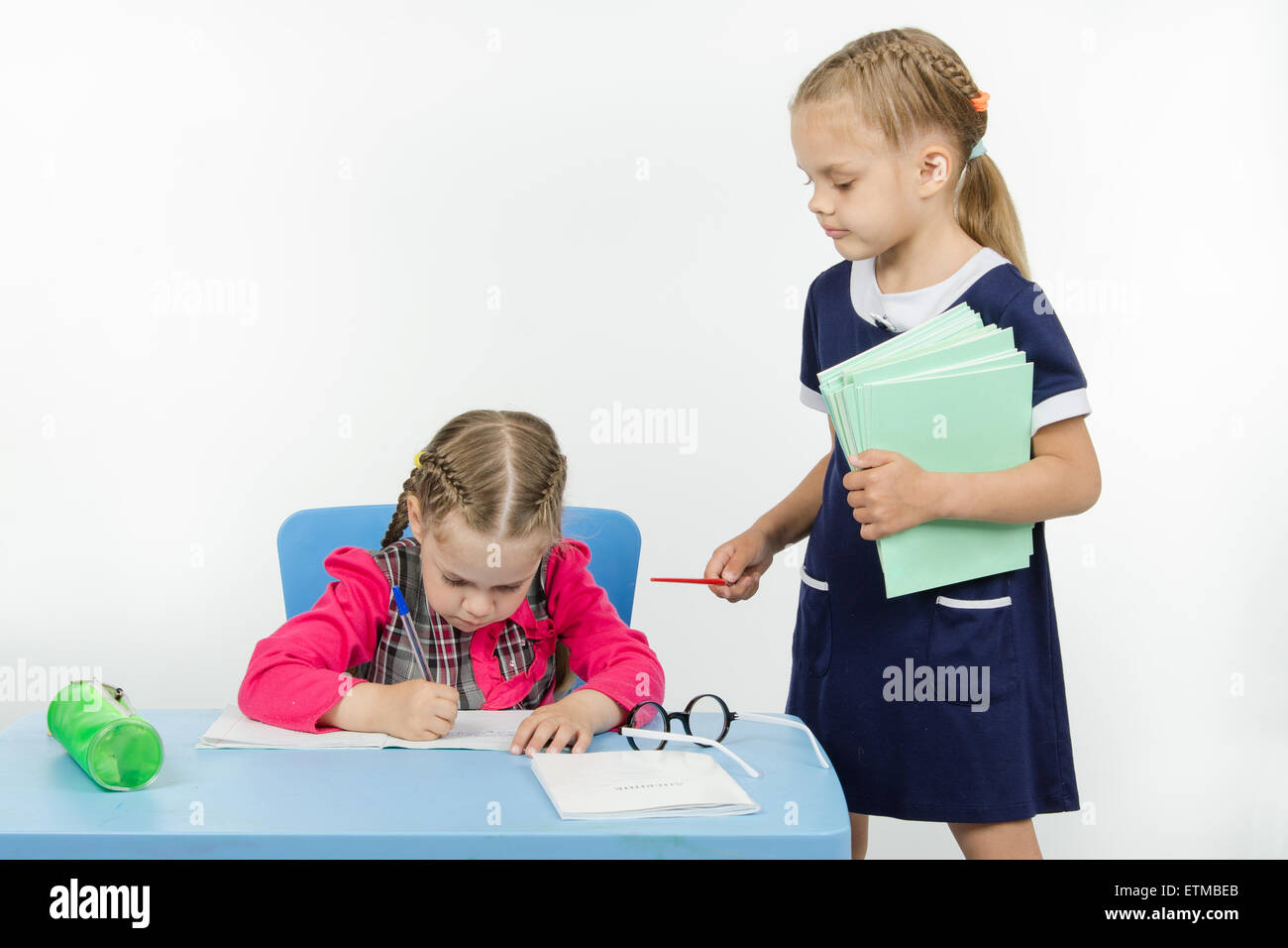 Two girls play school teacher and student Stock Photo