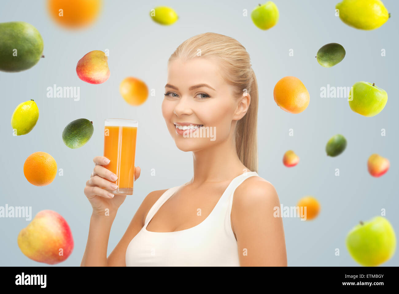 happy woman holding glass of orange juice Stock Photo