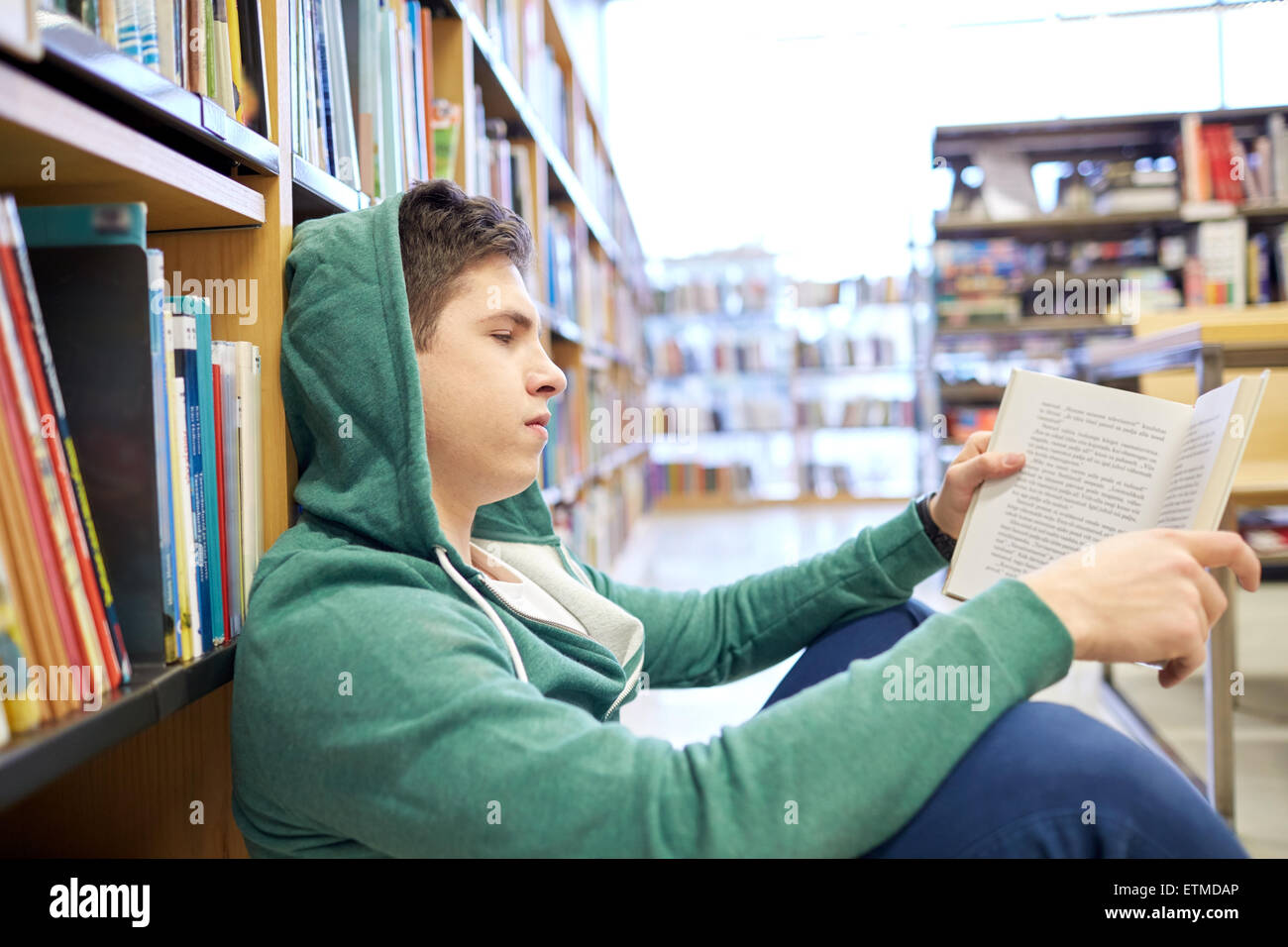 student boy or young man reading book in library Stock Photo