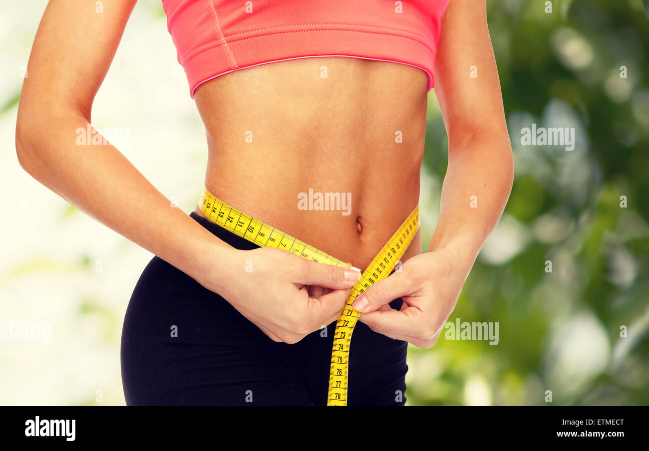  close up of female hands measuring waist Stock Photo - Alamy