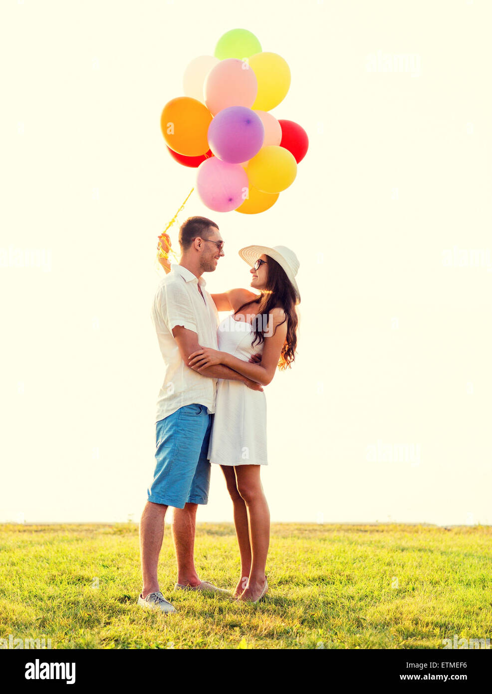 smiling couple with air balloons outdoors Stock Photo - Alamy