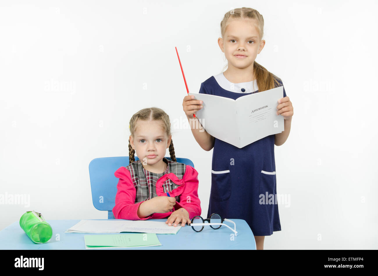 Two girls play school teacher and student Stock Photo