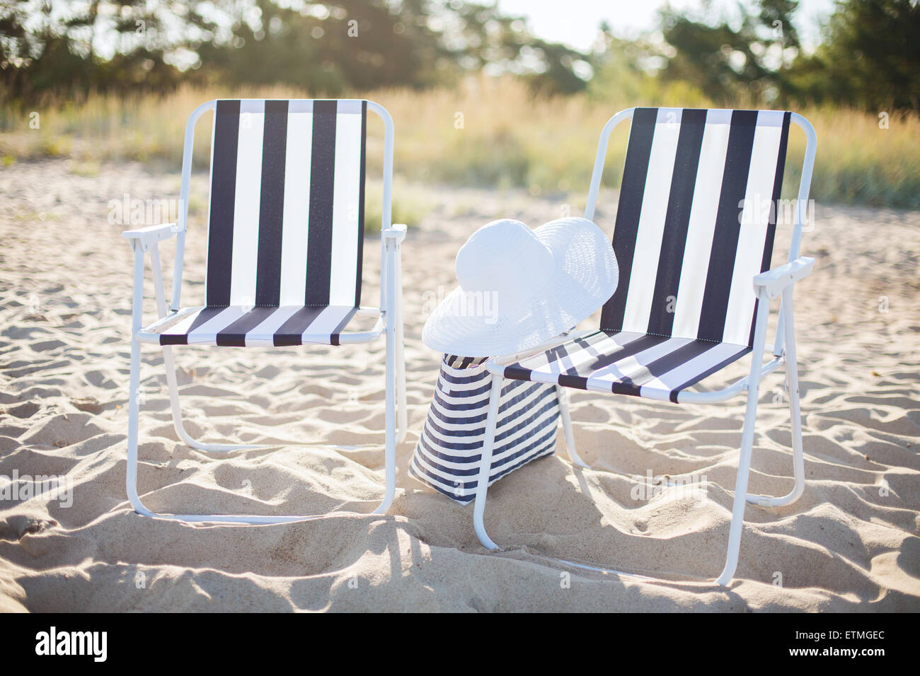 two beach lounges with beach bag and white hat Stock Photo