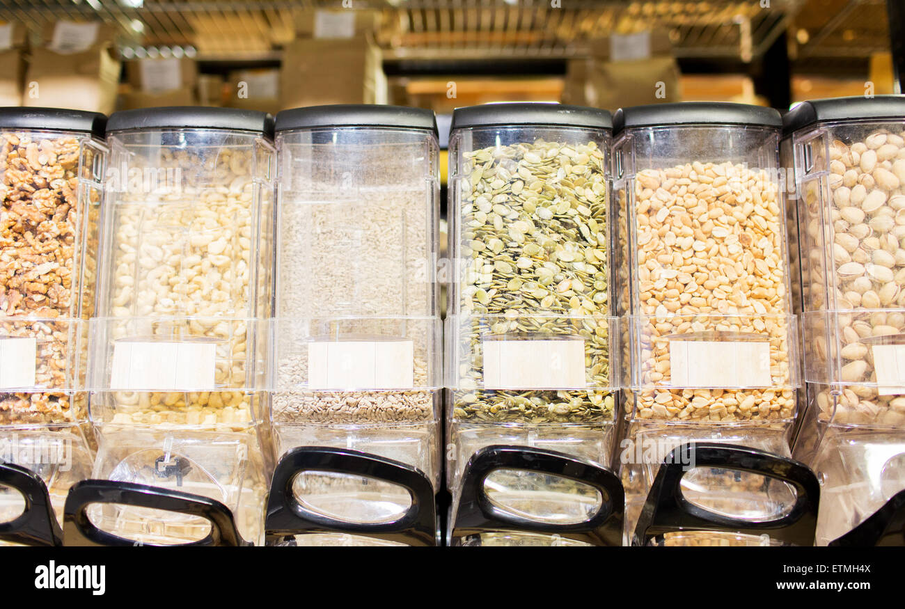 row of jars with nuts and seeds at grocery store Stock Photo Alamy