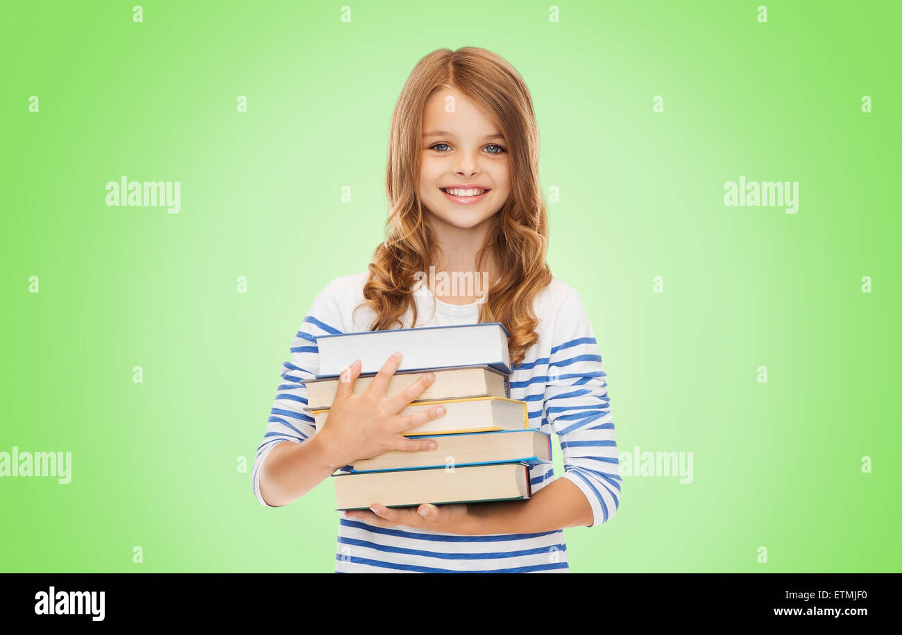 happy little student girl with many books Stock Photo - Alamy