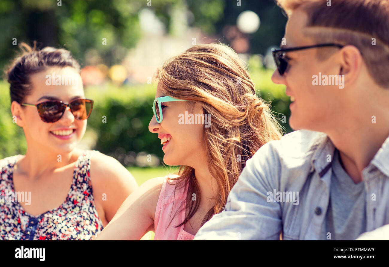 group of smiling friends outdoors sitting in park Stock Photo - Alamy