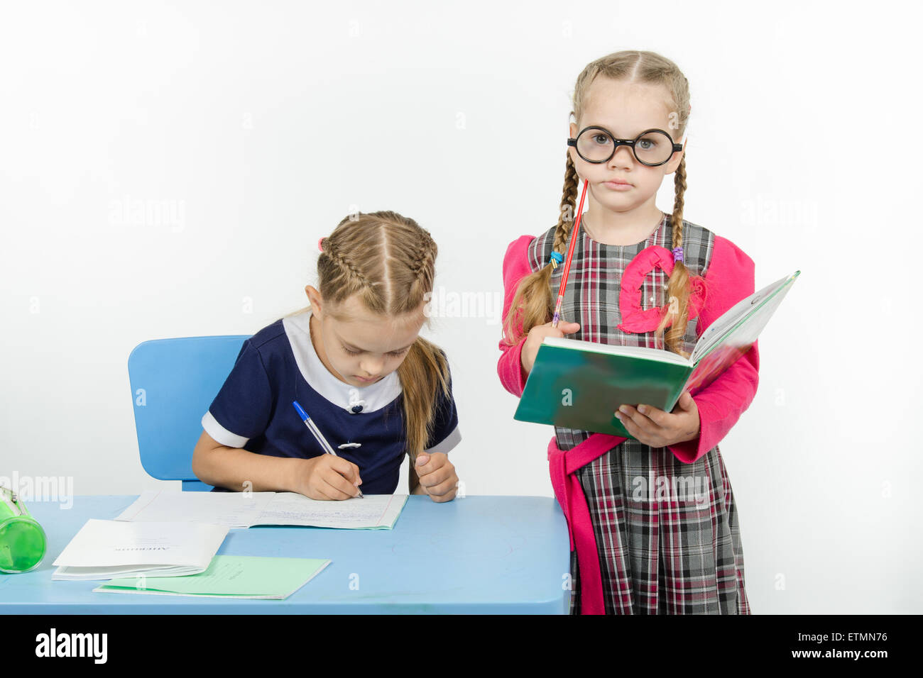 Two girls play school teacher and student Stock Photo